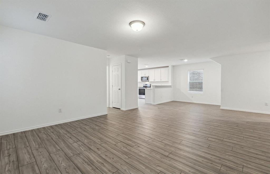820 Lake Fletcher Road Princeton, TX 75407 - Photo 15 of 15 a view of empty room with wooden floor
