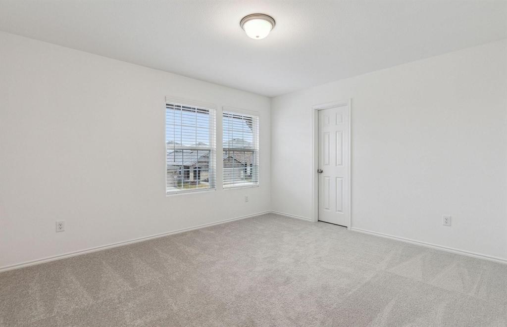 820 Lake Fletcher Road Princeton, TX 75407 - Photo 6 of 15 an empty room with windows