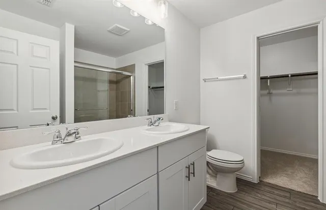a bathroom with a sink toilet and shower