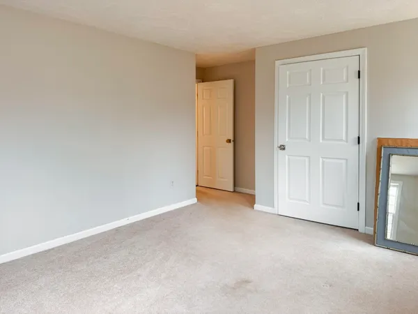 a view of an empty room and closet area