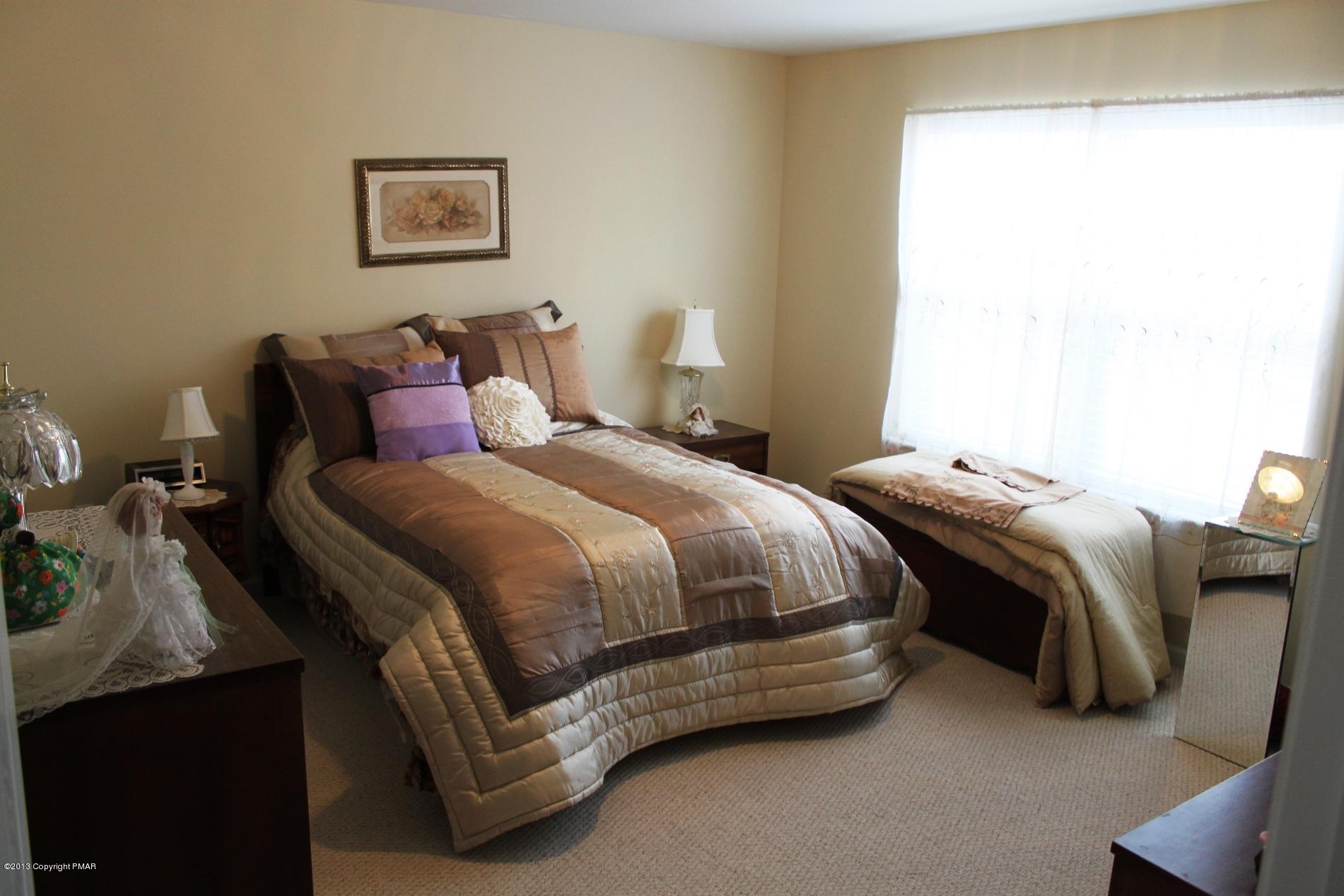 128 Ruth Drive Cresco, PA 18326 - Photo 18 of 28 a spacious bedroom with a bed and a window