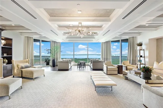 a living room with furniture and a chandelier