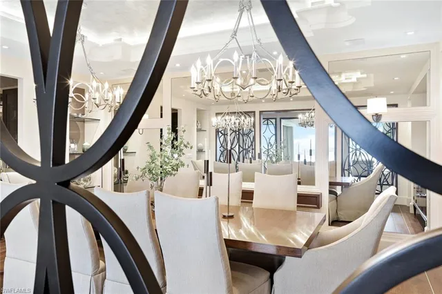 a view of an dining room with wooden floor and a chandelier