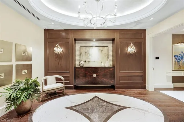 a living room with a couch and chandelier
