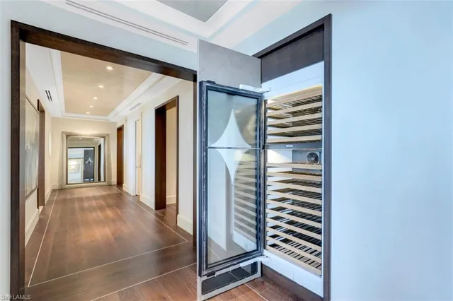 a view of a hallway with closet and a window