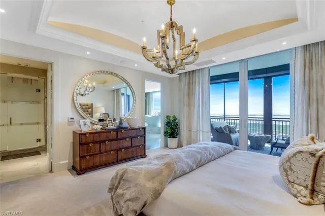 a large bedroom with bed and a large window