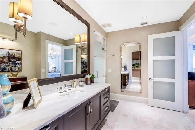 a spacious bathroom with a double vanity sink a mirror and a shower