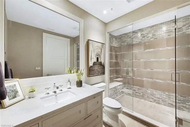 a bathroom with a sink toilet and shower