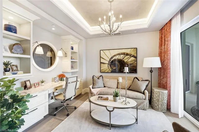 a living room with furniture and a chandelier