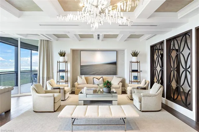 a living room with furniture and a chandelier