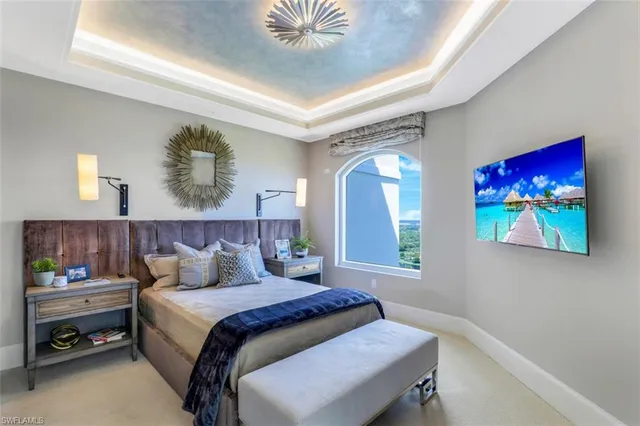 a bedroom with a bed and a painting on the wall