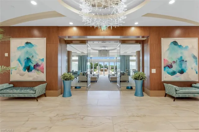 a living room with furniture and painting on the wall