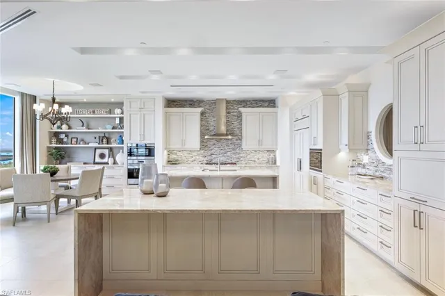 a view of kitchen with stainless steel appliances cabinets and outdoor view