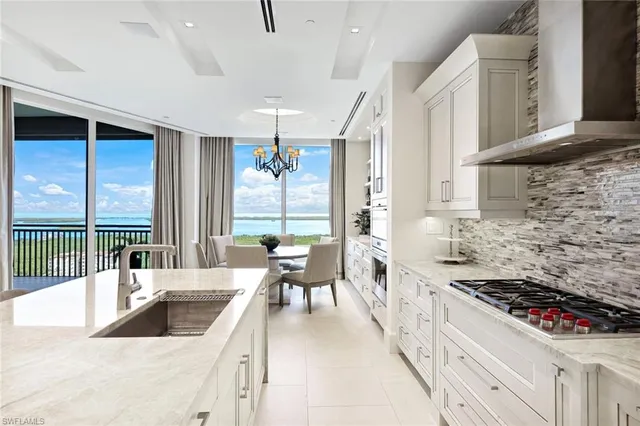 a large white kitchen with a large window
