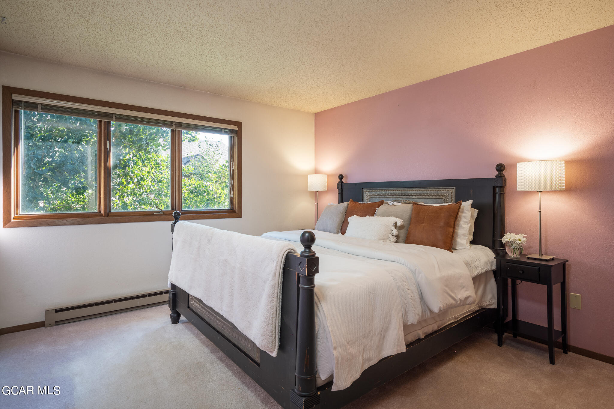 99 Doc Susie Avenue, Unit B6 Fraser, CO 80442 - Photo 15 of 24 a large bed sitting in a bedroom next to a window