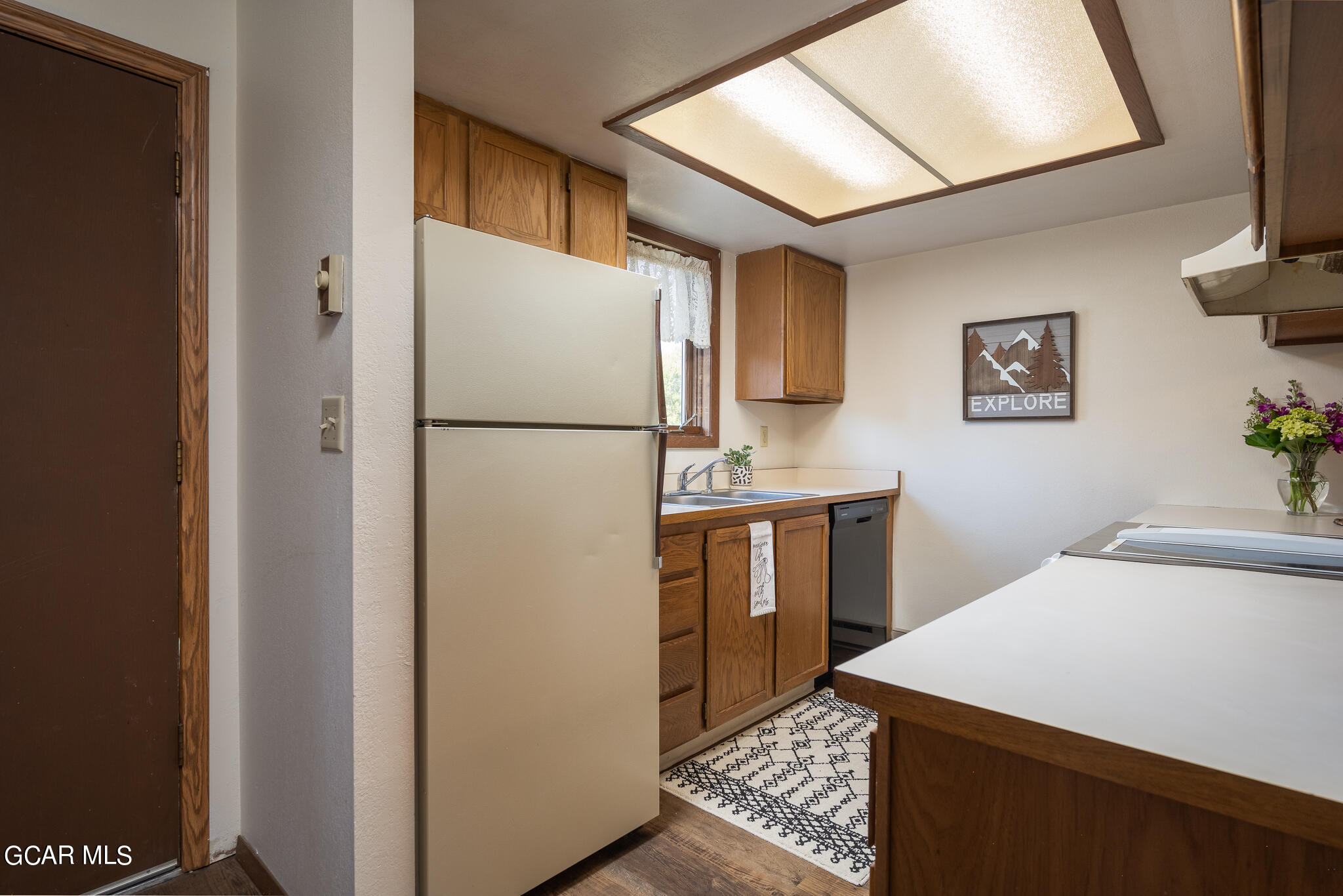 99 Doc Susie Avenue, Unit B6 Fraser, CO 80442 - Photo 19 of 24 a white refrigerator freezer sitting inside of a kitchen