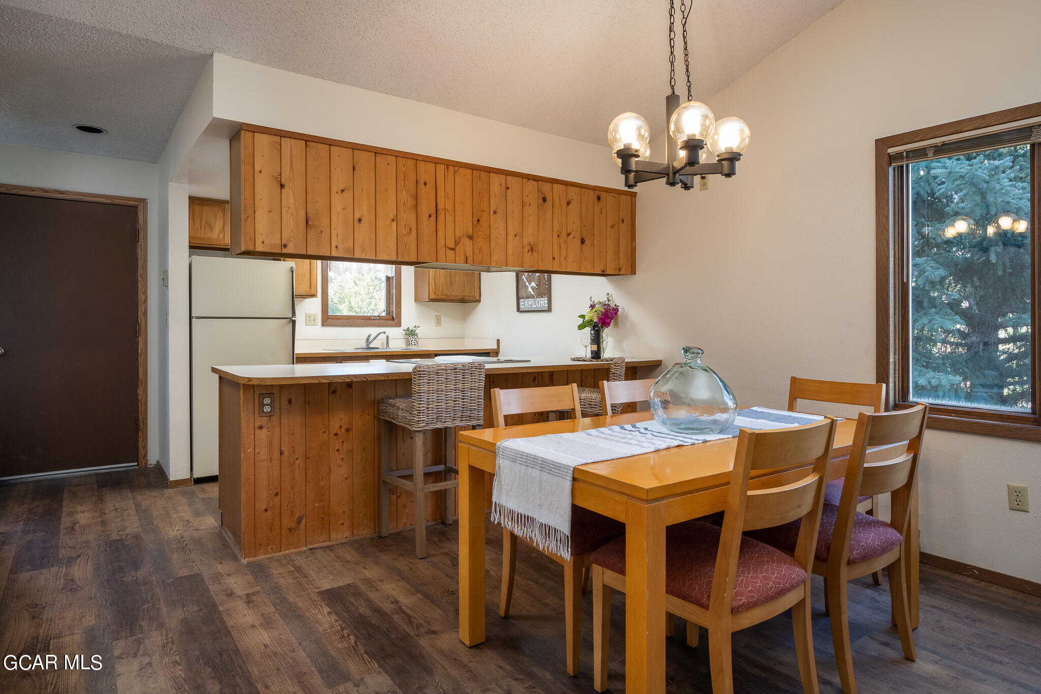 99 Doc Susie Avenue, Unit B6 Fraser, CO 80442 - Photo 20 of 24 a dining room with a wooden table and chairs