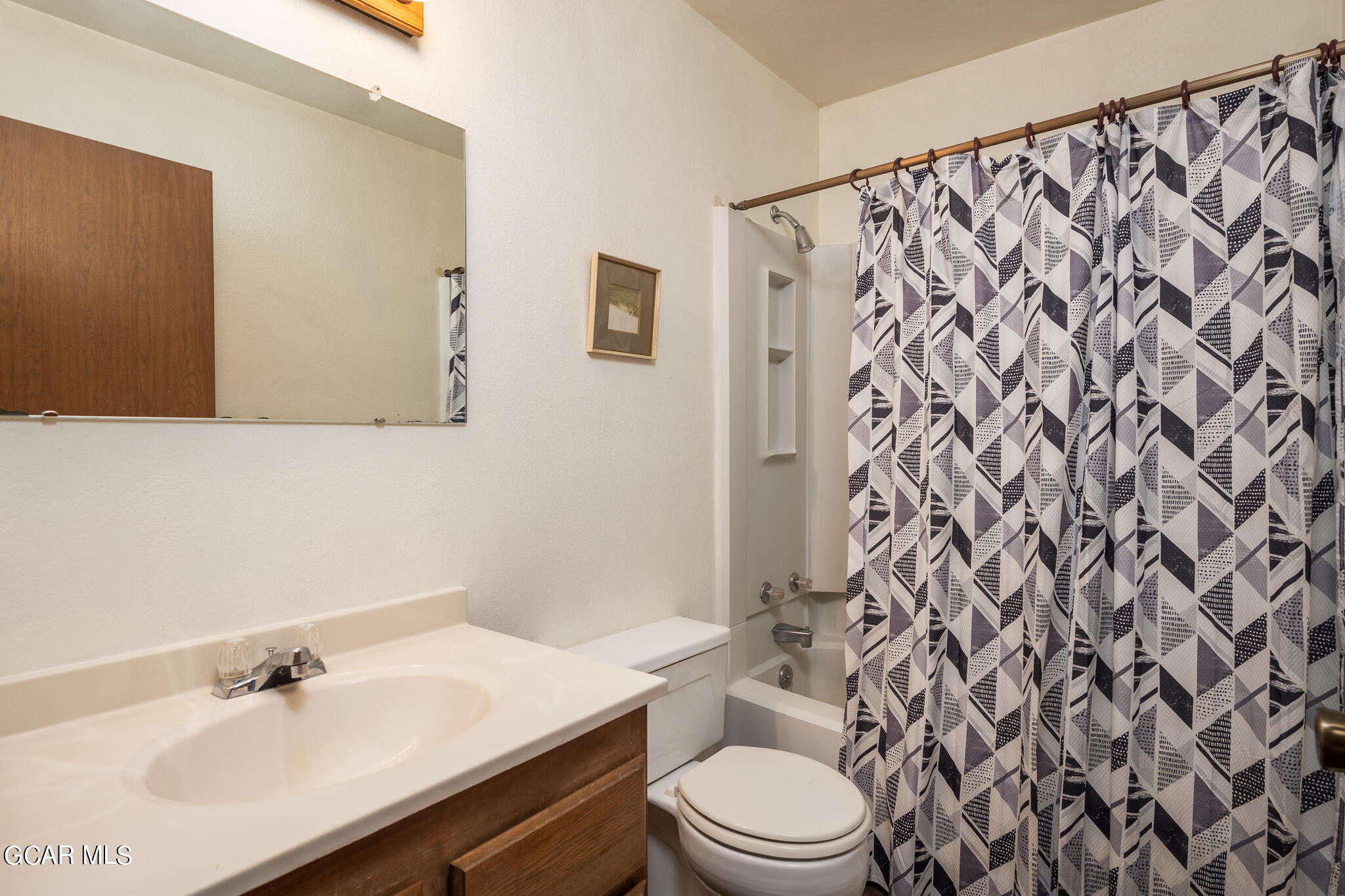99 Doc Susie Avenue, Unit B6 Fraser, CO 80442 - Photo 22 of 24 a bathroom with a sink a toilet and shower curtain