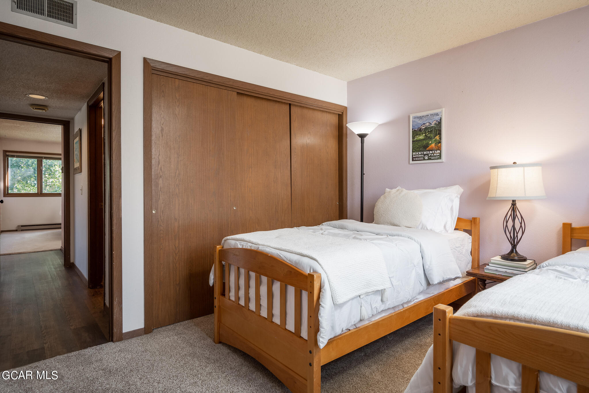 99 Doc Susie Avenue, Unit B6 Fraser, CO 80442 - Photo 23 of 24 a bedroom with two beds and a lamp