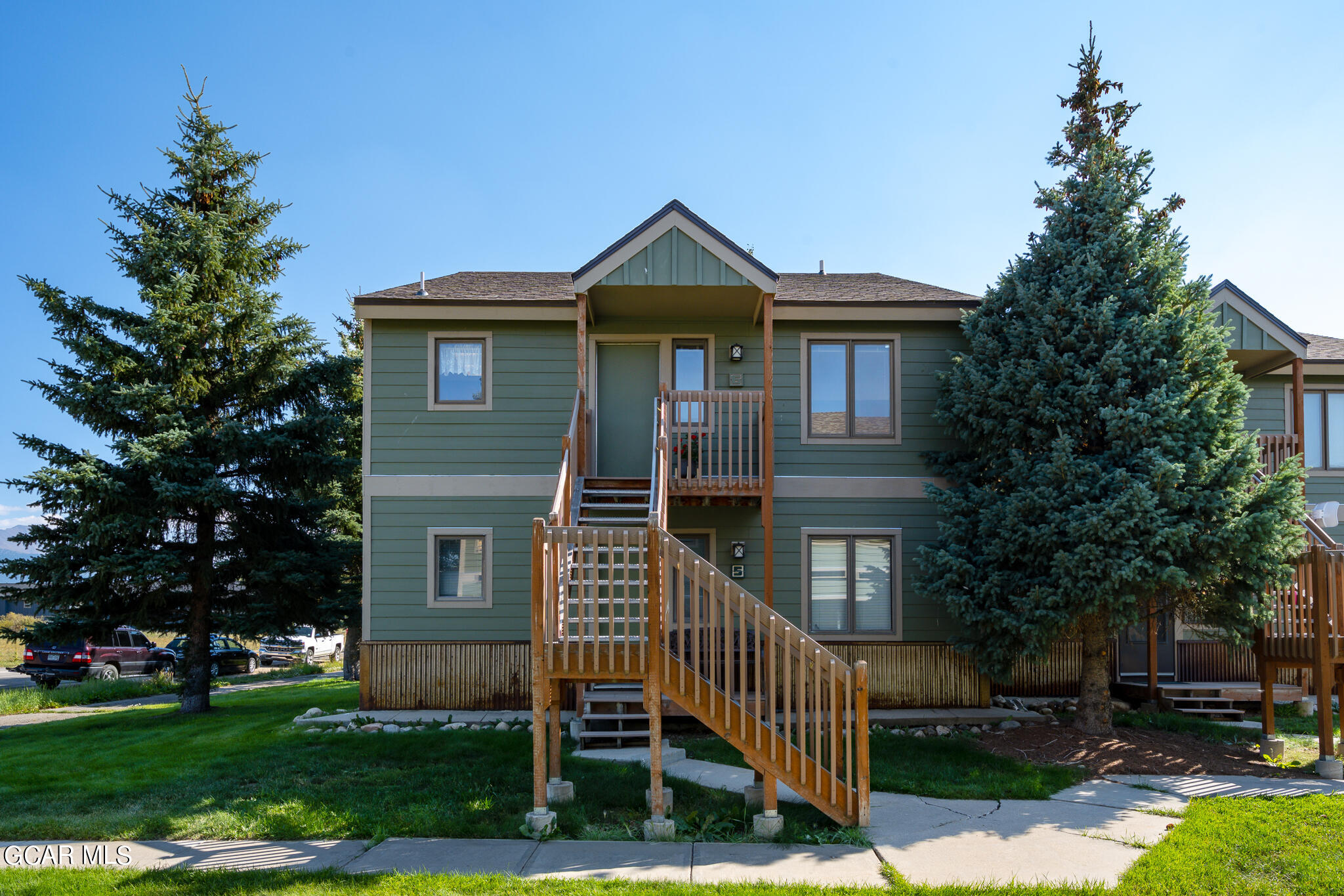 99 Doc Susie Avenue, Unit B6 Fraser, CO 80442 - Photo 3 of 24 a front view of a house with garden