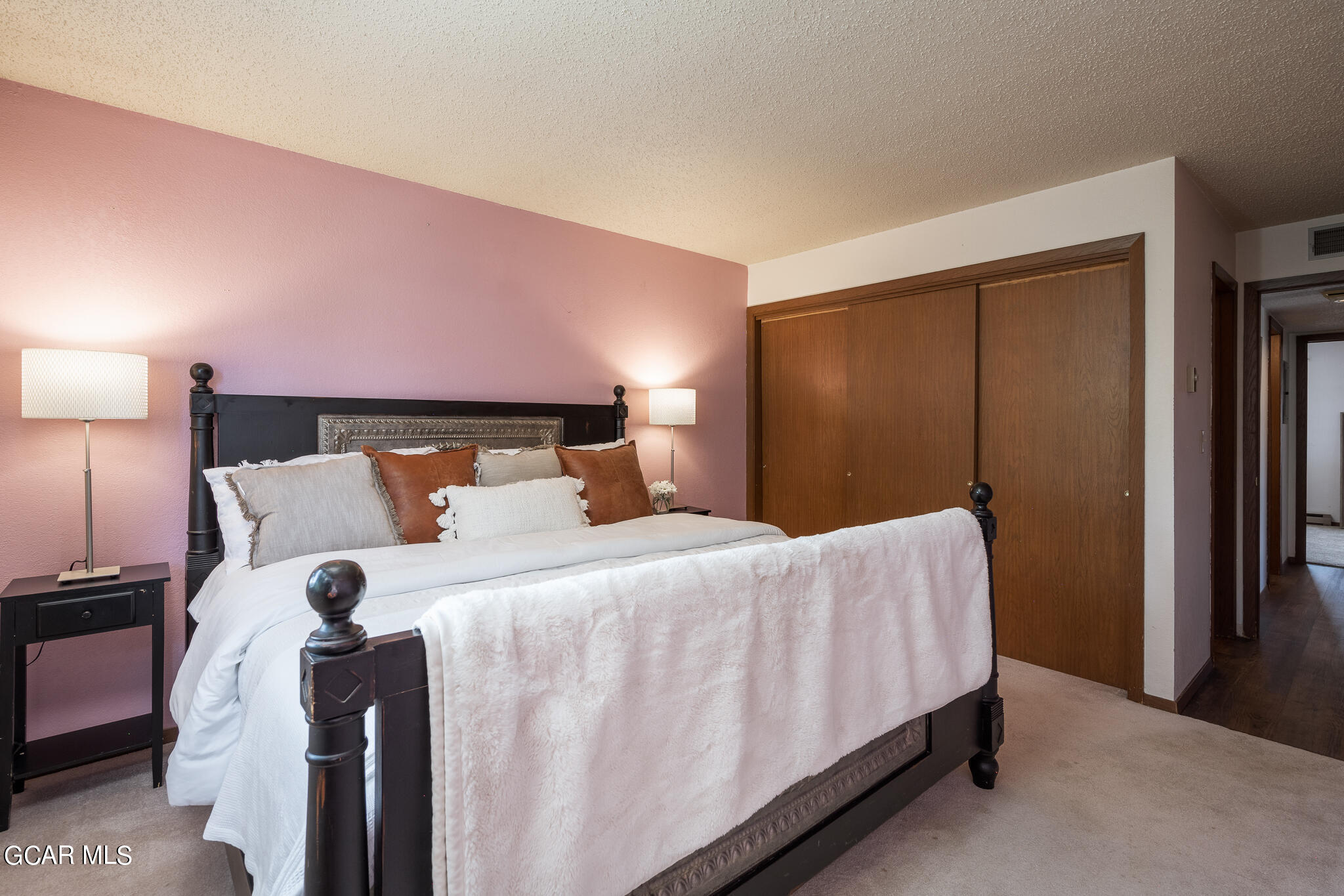 99 Doc Susie Avenue, Unit B6 Fraser, CO 80442 - Photo 7 of 24 a bedroom with a bed and a lamp