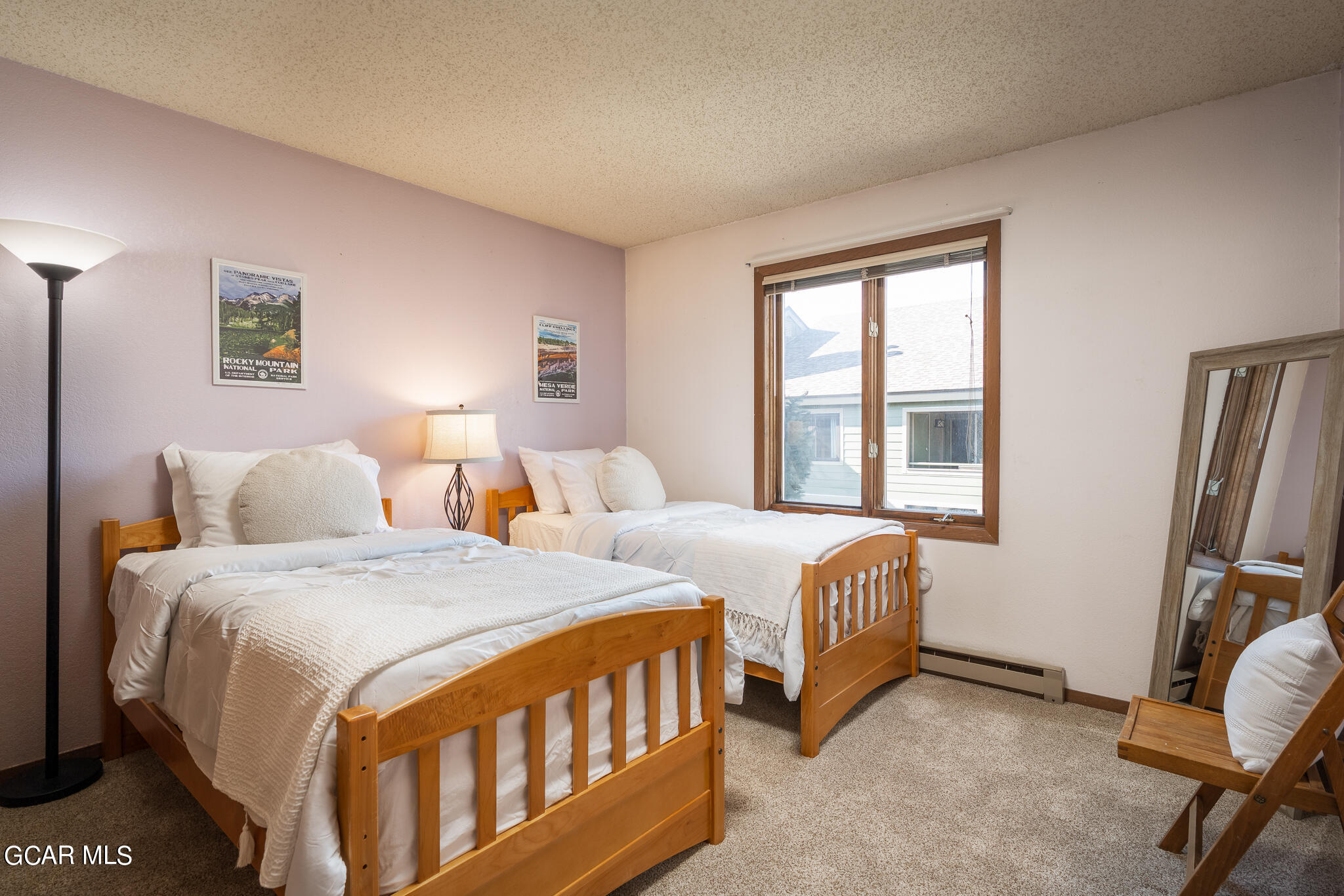 99 Doc Susie Avenue, Unit B6 Fraser, CO 80442 - Photo 10 of 24 a bedroom with two beds and a window