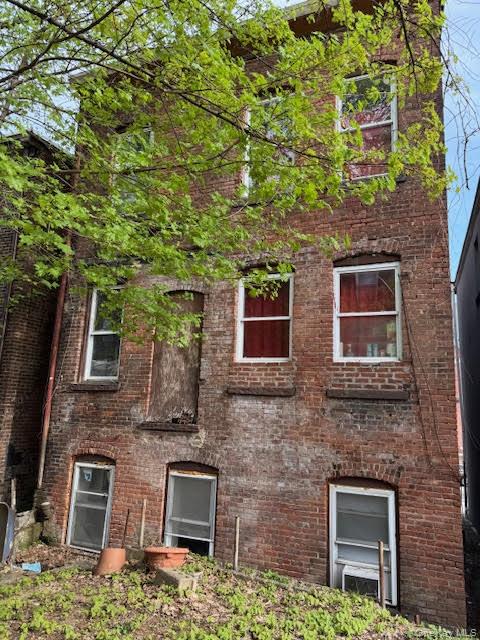 95 Renwick Street Newburgh, NY 12550 - Photo 18 of 24 front view of a brick house with a small yard