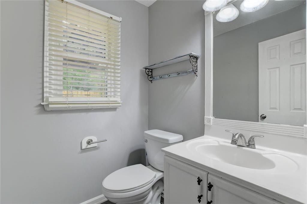 2610 Loring Road Northwest Kennesaw, GA 30152 - Photo 13 of 28 a bathroom with a sink vanity granite toilet and a mirror