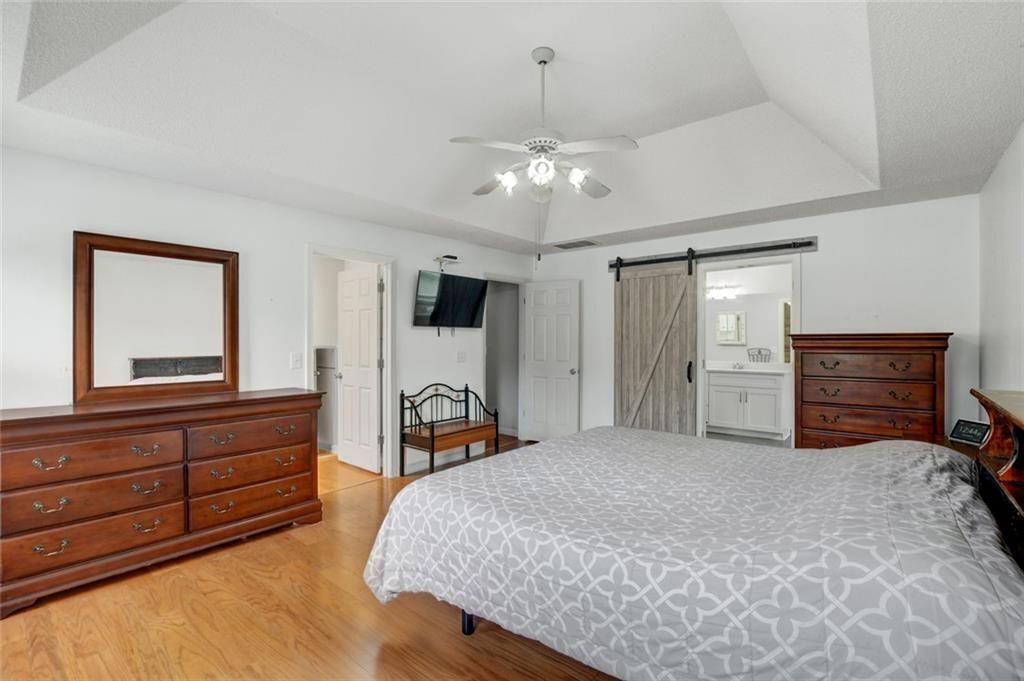 2610 Loring Road Northwest Kennesaw, GA 30152 - Photo 14 of 28 a spacious bedroom with a bed and a dresser