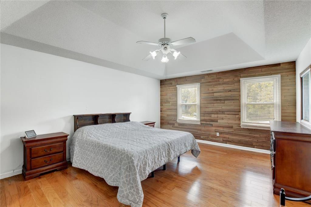 2610 Loring Road Northwest Kennesaw, GA 30152 - Photo 15 of 28 a bedroom with a bed and a dresser next to a window