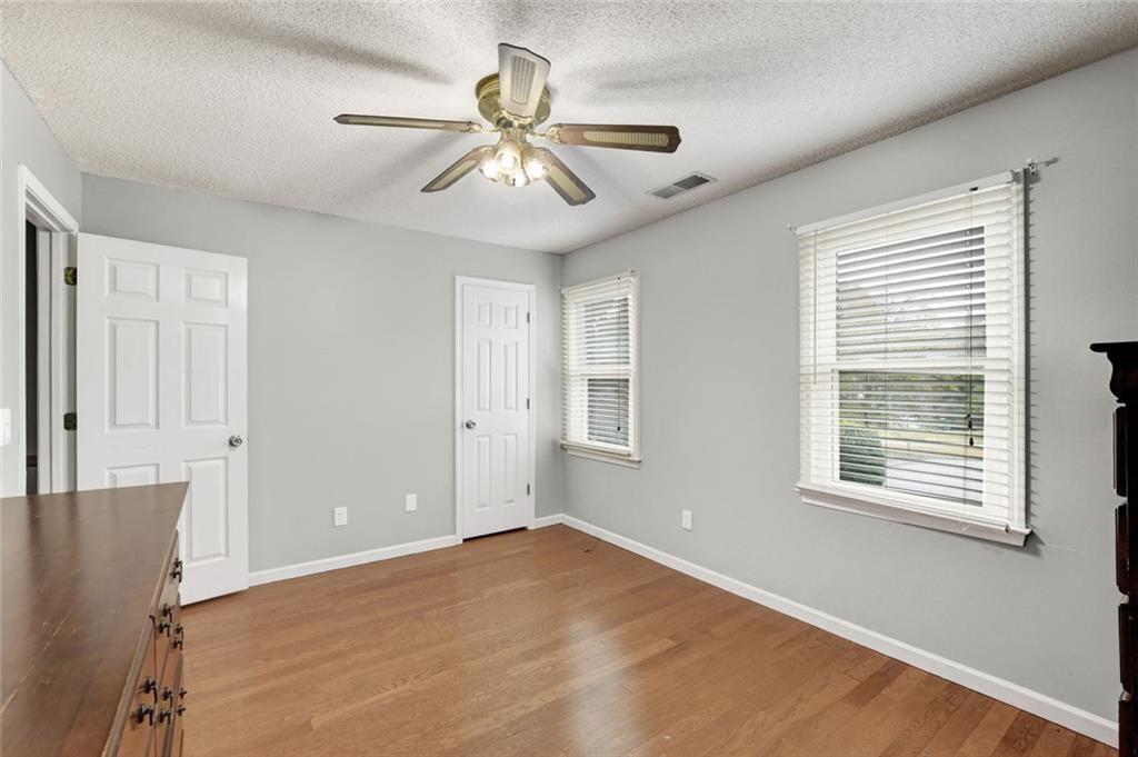 2610 Loring Road Northwest Kennesaw, GA 30152 - Photo 20 of 28 a view of an empty room with a window and wooden floor