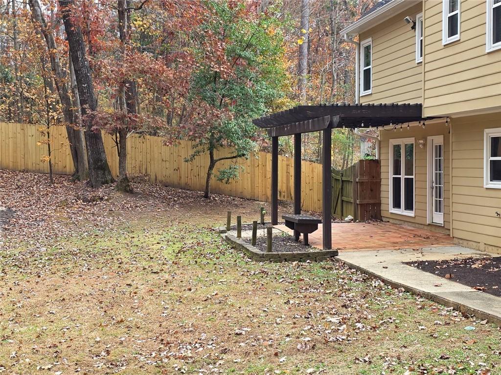2610 Loring Road Northwest Kennesaw, GA 30152 - Photo 25 of 28 a view of a house with backyard and sitting area