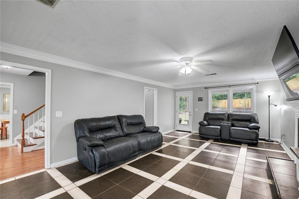 2610 Loring Road Northwest Kennesaw, GA 30152 - Photo 6 of 28 a living room with furniture and a flat screen tv