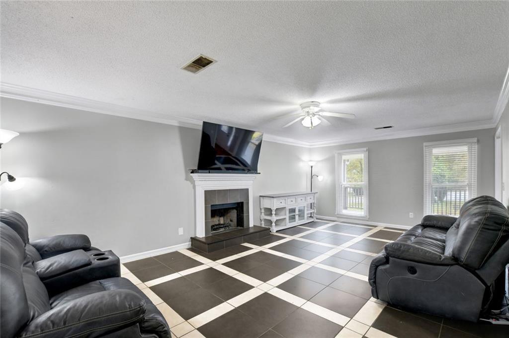 2610 Loring Road Northwest Kennesaw, GA 30152 - Photo 7 of 28 a living room with furniture a flat screen tv and a fireplace