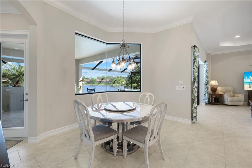 1456 Mockingbird Drive Naples, FL 34120 - Photo 14 of 43 Dining area with ornamental molding, a chandelier, arched walkways, recessed lighting, and light tile patterned floors