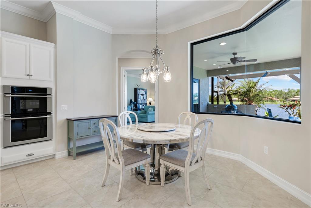 1456 Mockingbird Drive Naples, FL 34120 - Photo 15 of 43 Dining room with a chandelier, light tile patterned floors, crown molding, a ceiling fan, and recessed lighting