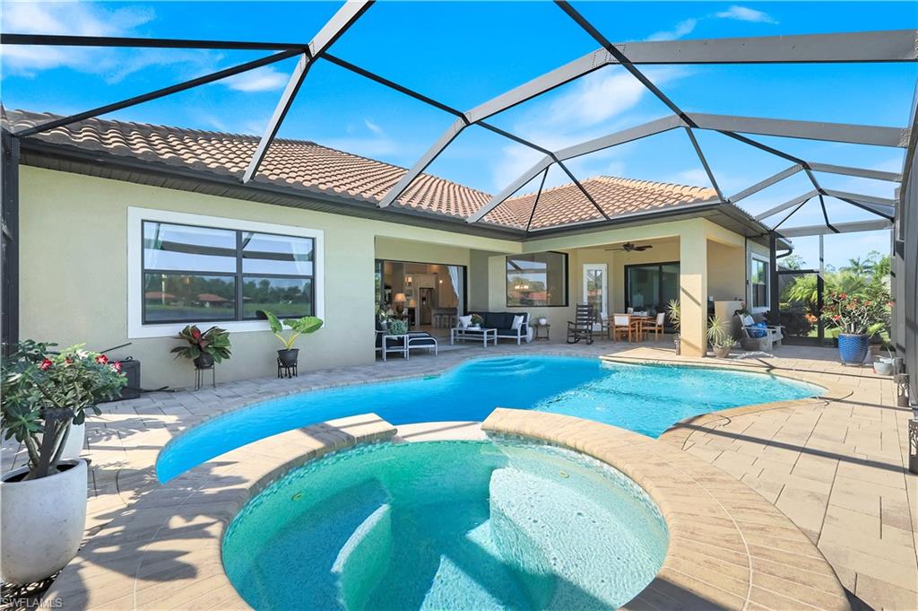 1456 Mockingbird Drive Naples, FL 34120 - Photo 17 of 43 View of pool featuring a sunroom, a patio, a pool with connected hot tub, and a lanai