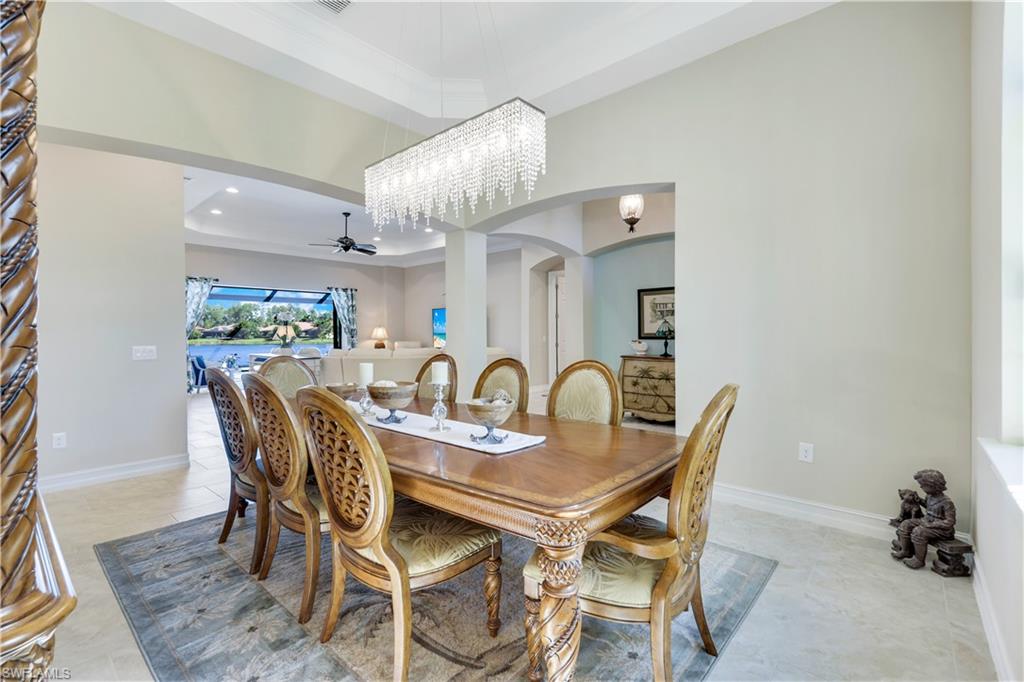 1456 Mockingbird Drive Naples, FL 34120 - Photo 19 of 43 Dining space with ceiling fan, arched walkways, a chandelier, recessed lighting, and a towering ceiling
