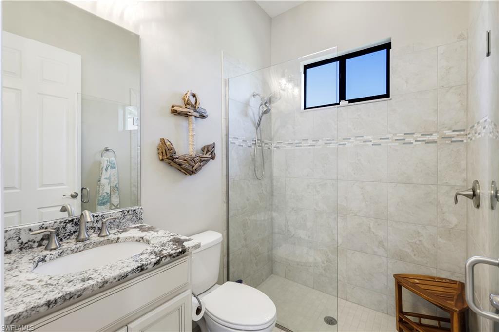1456 Mockingbird Drive Naples, FL 34120 - Photo 25 of 43 Full bath featuring vanity and a walk in shower