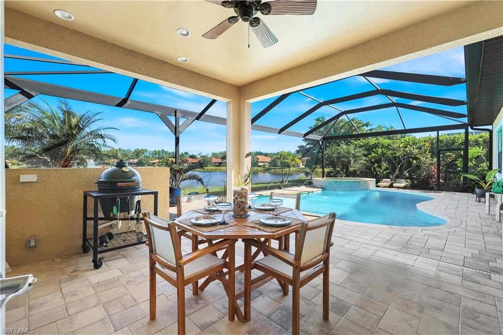 1456 Mockingbird Drive Naples, FL 34120 - Photo 35 of 43 a view of a patio with a table and chairs under an umbrella
