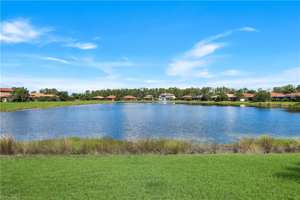 1456 Mockingbird Drive Naples, FL 34120 - Photo 36 of 43 a view of a lake with houses in the background