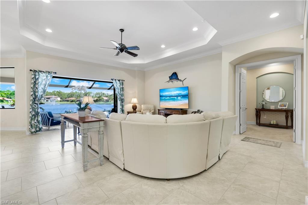 1456 Mockingbird Drive Naples, FL 34120 - Photo 5 of 43 Living area with a tray ceiling, a ceiling fan, recessed lighting, crown molding, and a sunroom