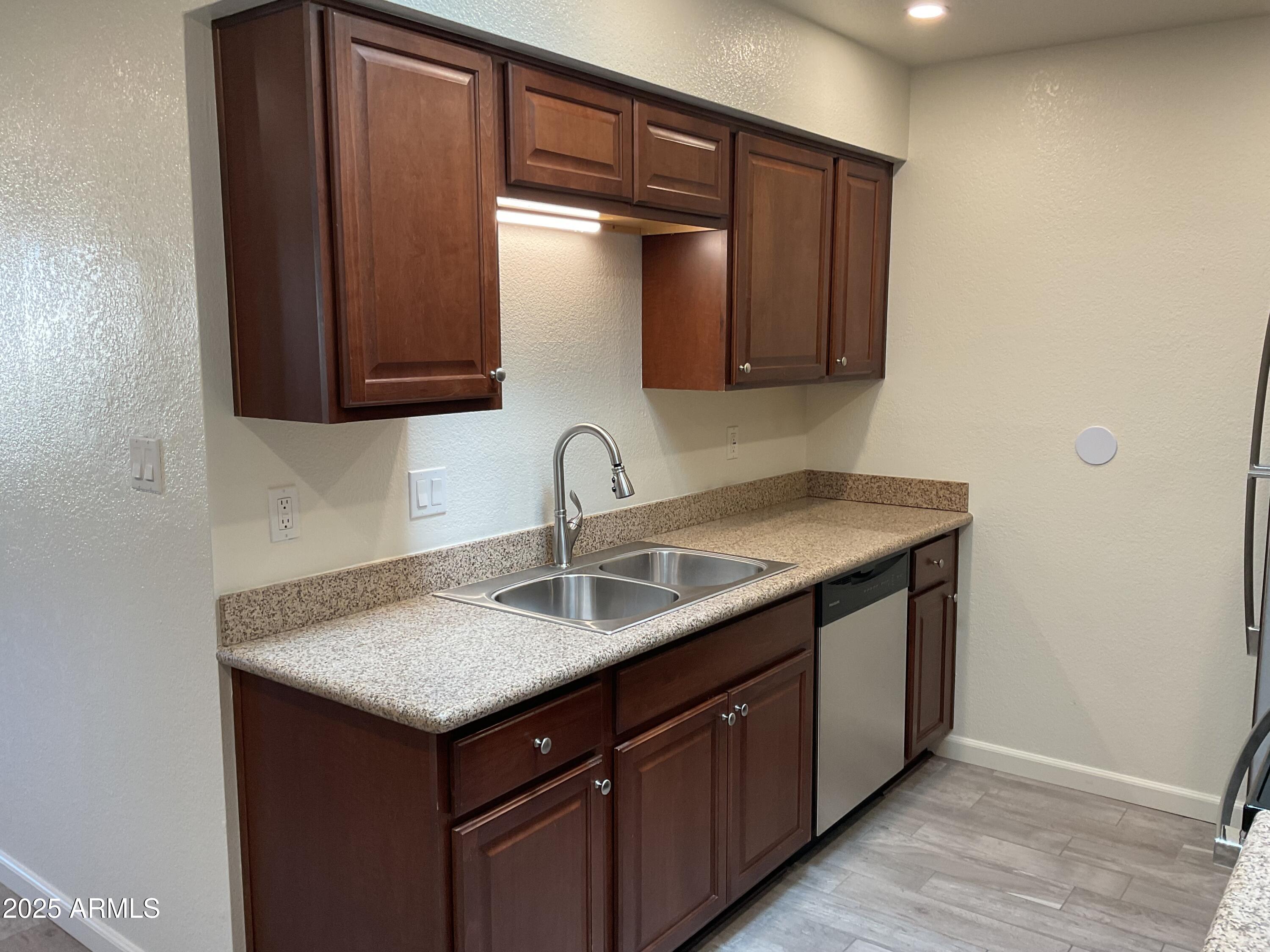 95 North Cooper Road, Unit 75 Chandler, AZ 85225 - Photo 4 of 19 a kitchen with a sink and cabinets