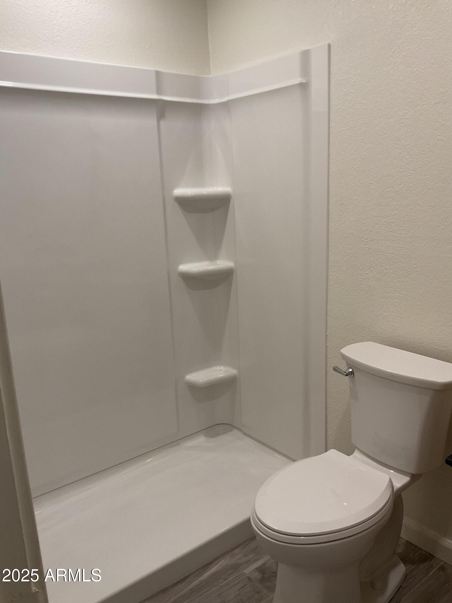 95 North Cooper Road, Unit 75 Chandler, AZ 85225 - Photo 9 of 19 a white toilet sitting next to a shower