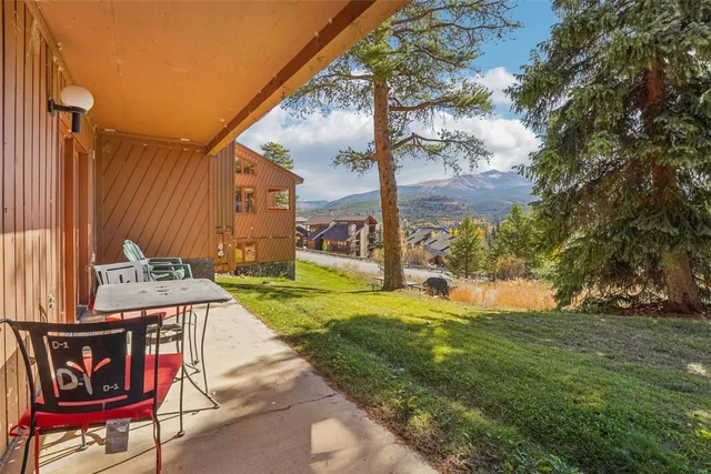 a view of an house with backyard and patio