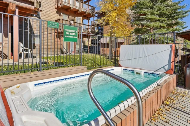a view of a fountain with a bench in patio