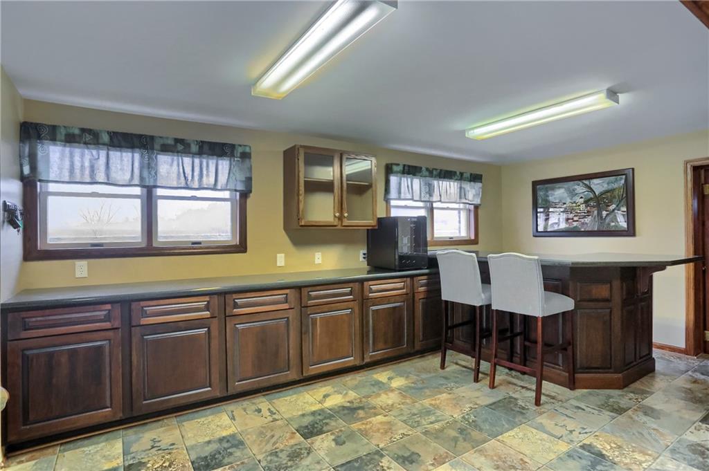 3305 State Road New Castle, PA 16105 - Photo 6 of 35 a large kitchen with stainless steel appliances granite countertop wooden cabinets a dining table and chairs