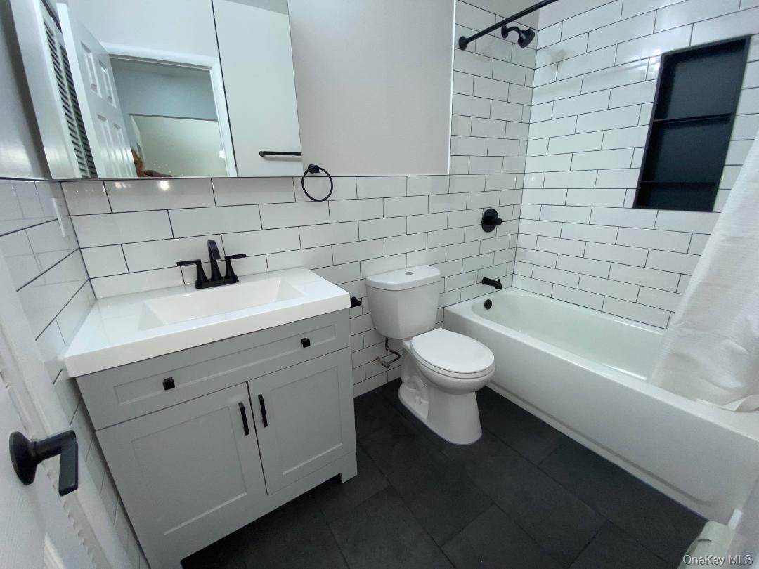 85 North Middletown Road, Unit E3 Nanuet, NY 10954 - Photo 15 of 20 Pretty updated bathroom which features a vanity featuring a light gray shaker-style cabinet, integrated sink, and matte black hardware