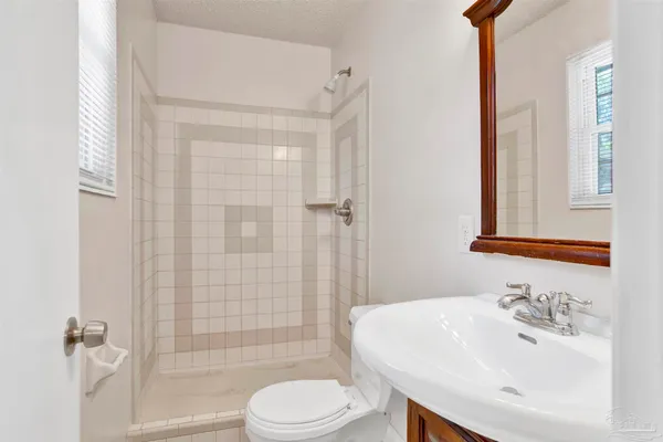a bathroom with a sink toilet and shower