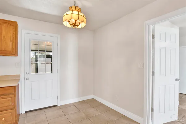 an empty room with wooden floor and window